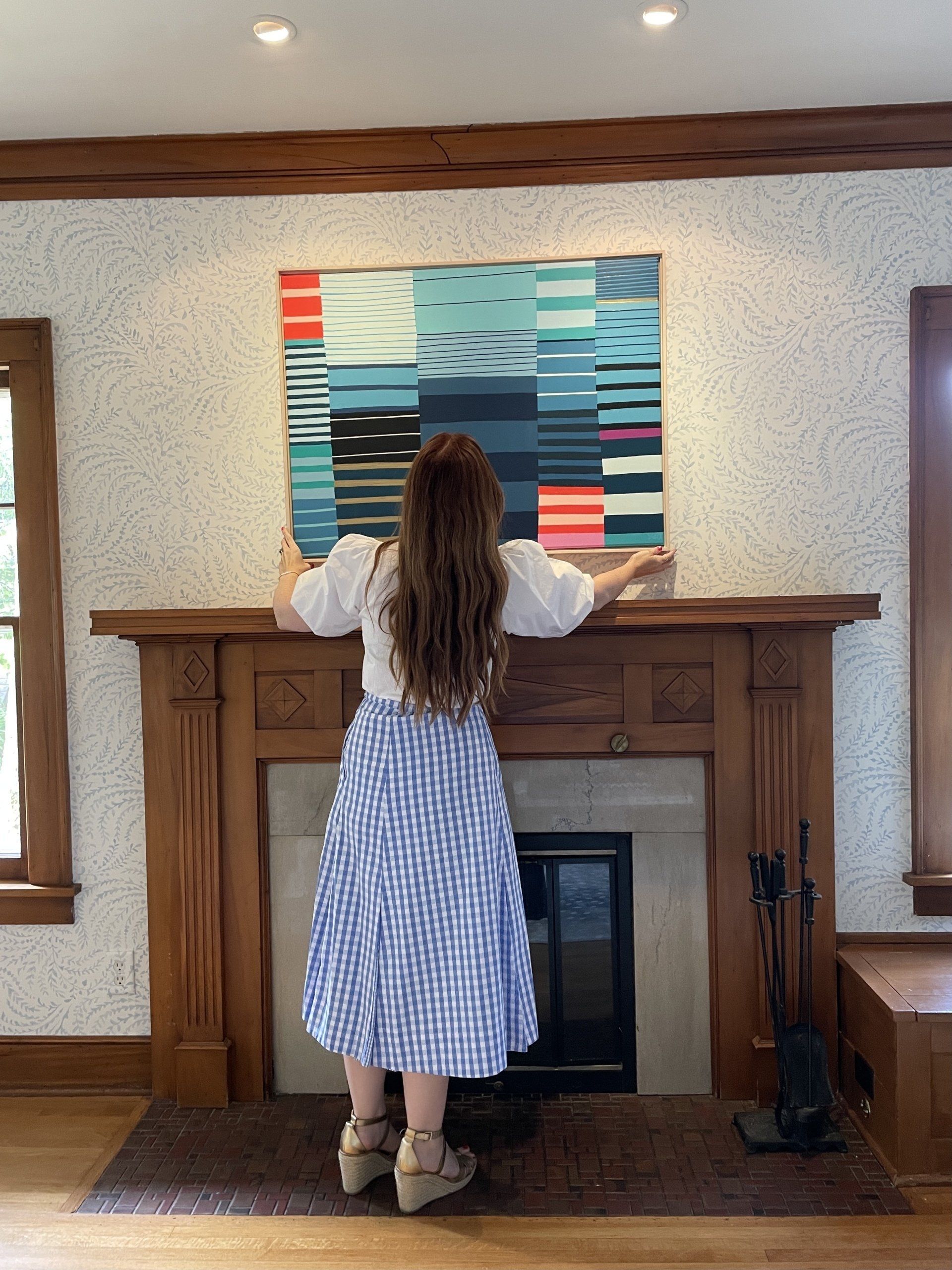 Liz hanging her Katie Craig original artwork
