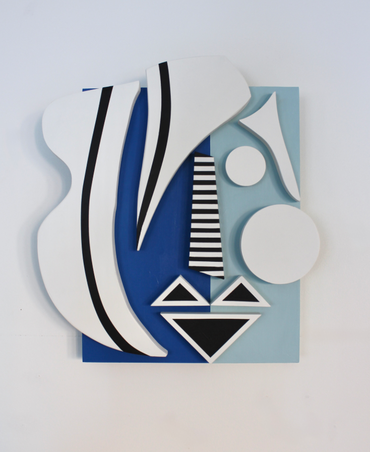 Another face featuring blue, white, and black three dimensional geometric abstractions