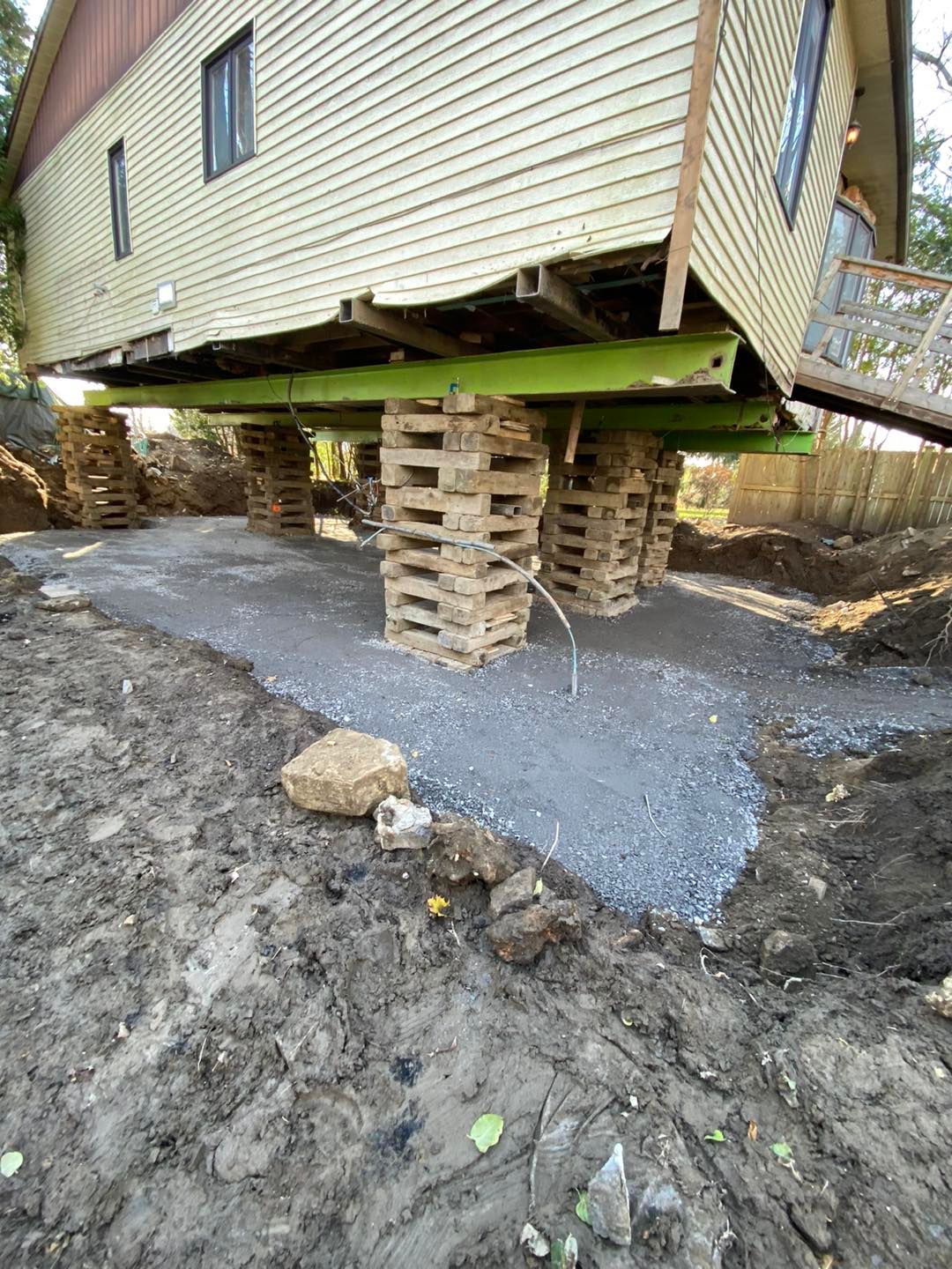 La maison a été soulevée sur des coffrages en bois pour les travaux de fondation, et repose sur une base de gravier.