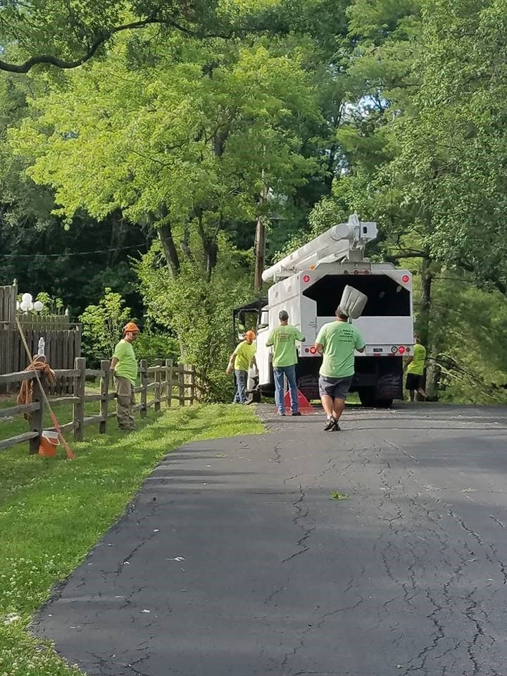 A group of people are walking down a road next to a truck.