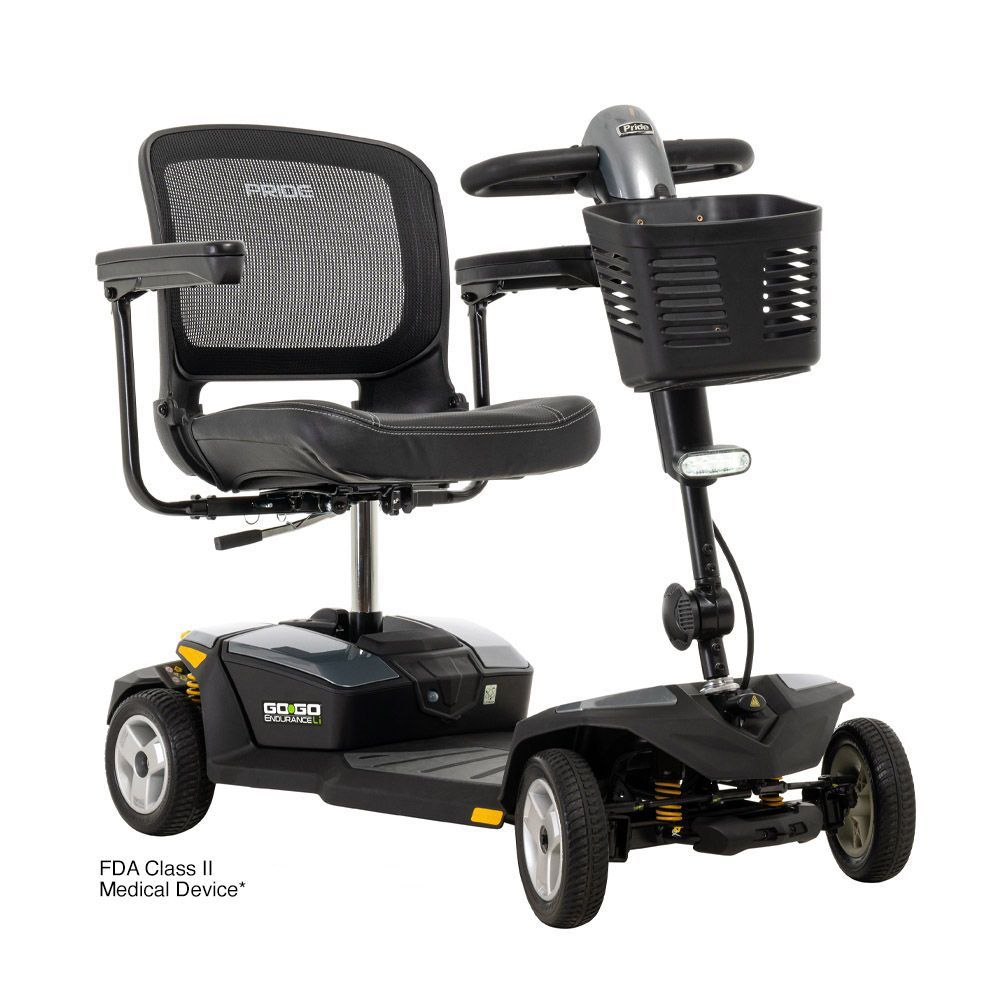 Black mobility scooter with mesh seat, front basket, and three wheels on a white background