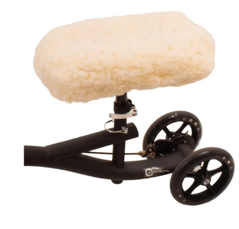 Black scooter with two wheels and a large white foam seat on a white background
