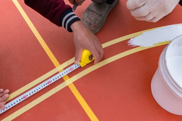 man measuring a line