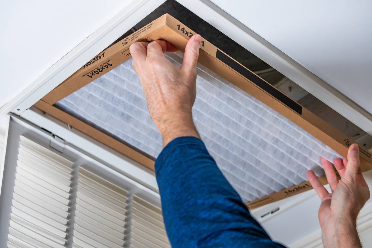 Image of a person changing a furnace air filter