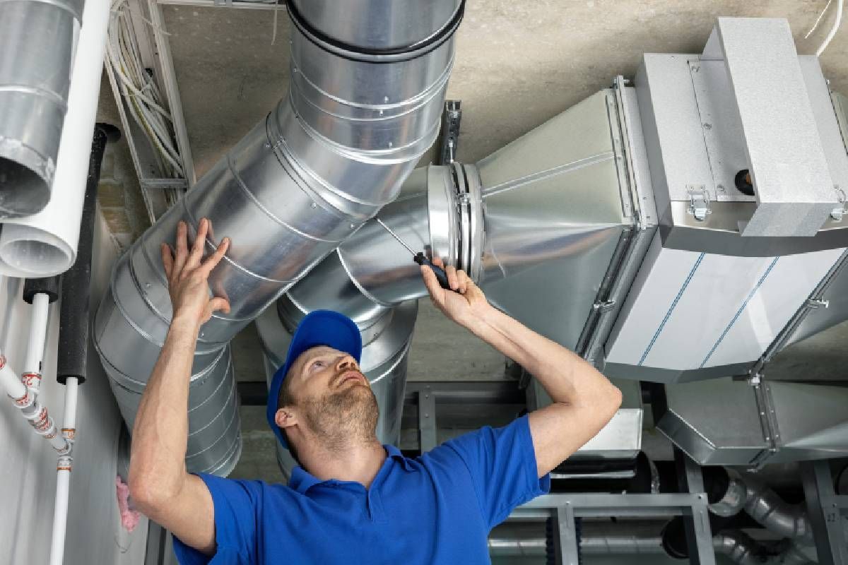 A HVAC service technician finishing a repair on an air duct near Lexington, Kentucky (KY)