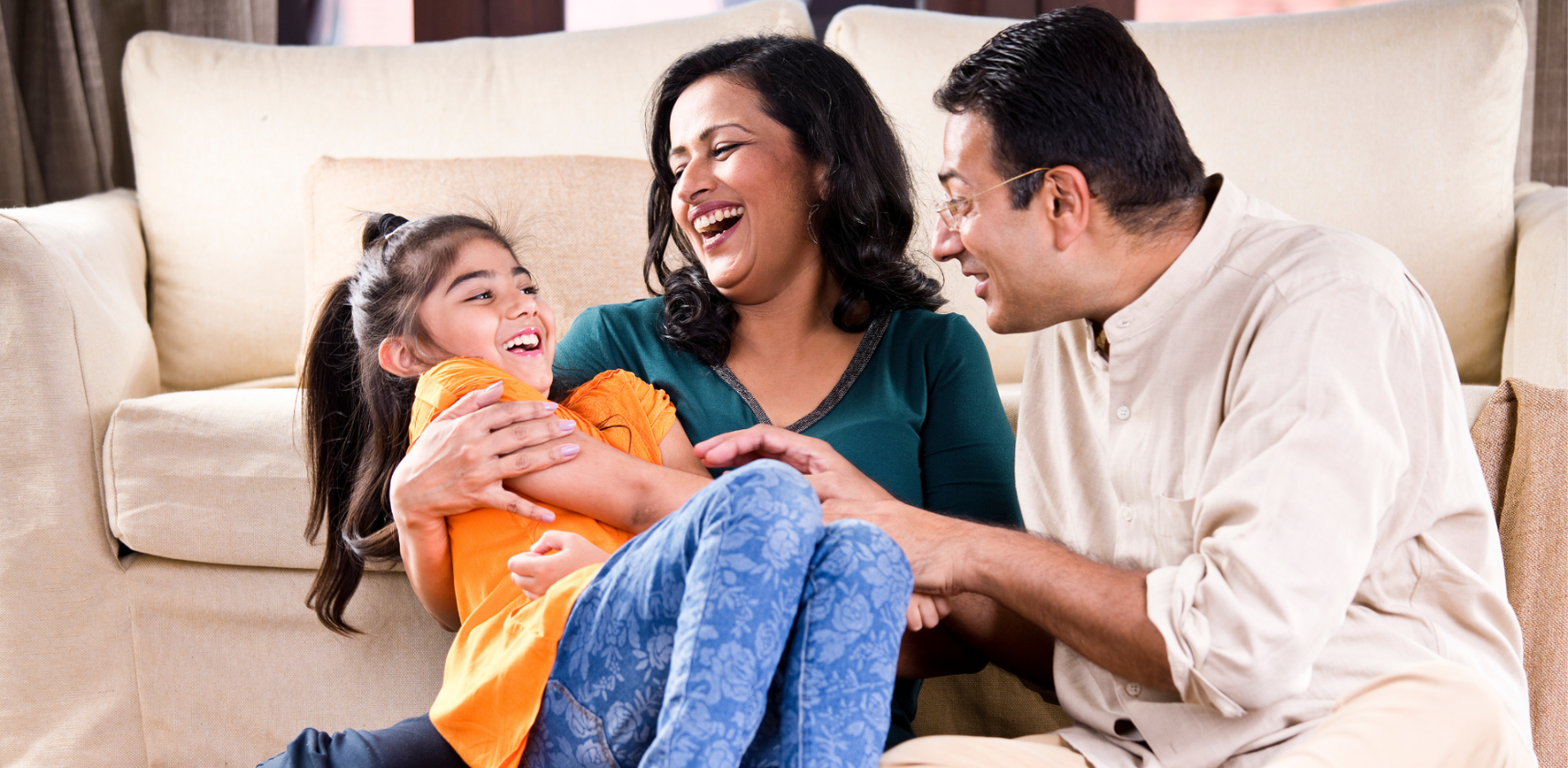 Family laughing on the couch
