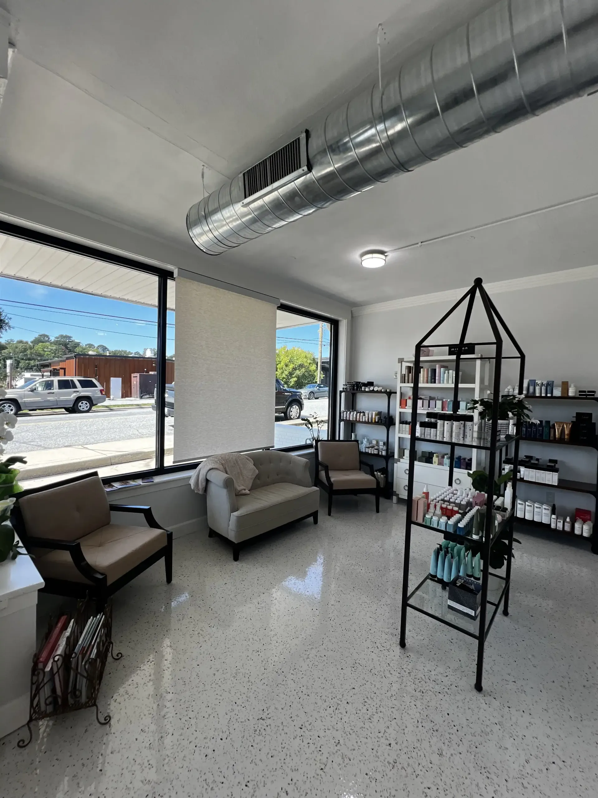 A living room with a couch , chairs , shelves and a sign that says notice.