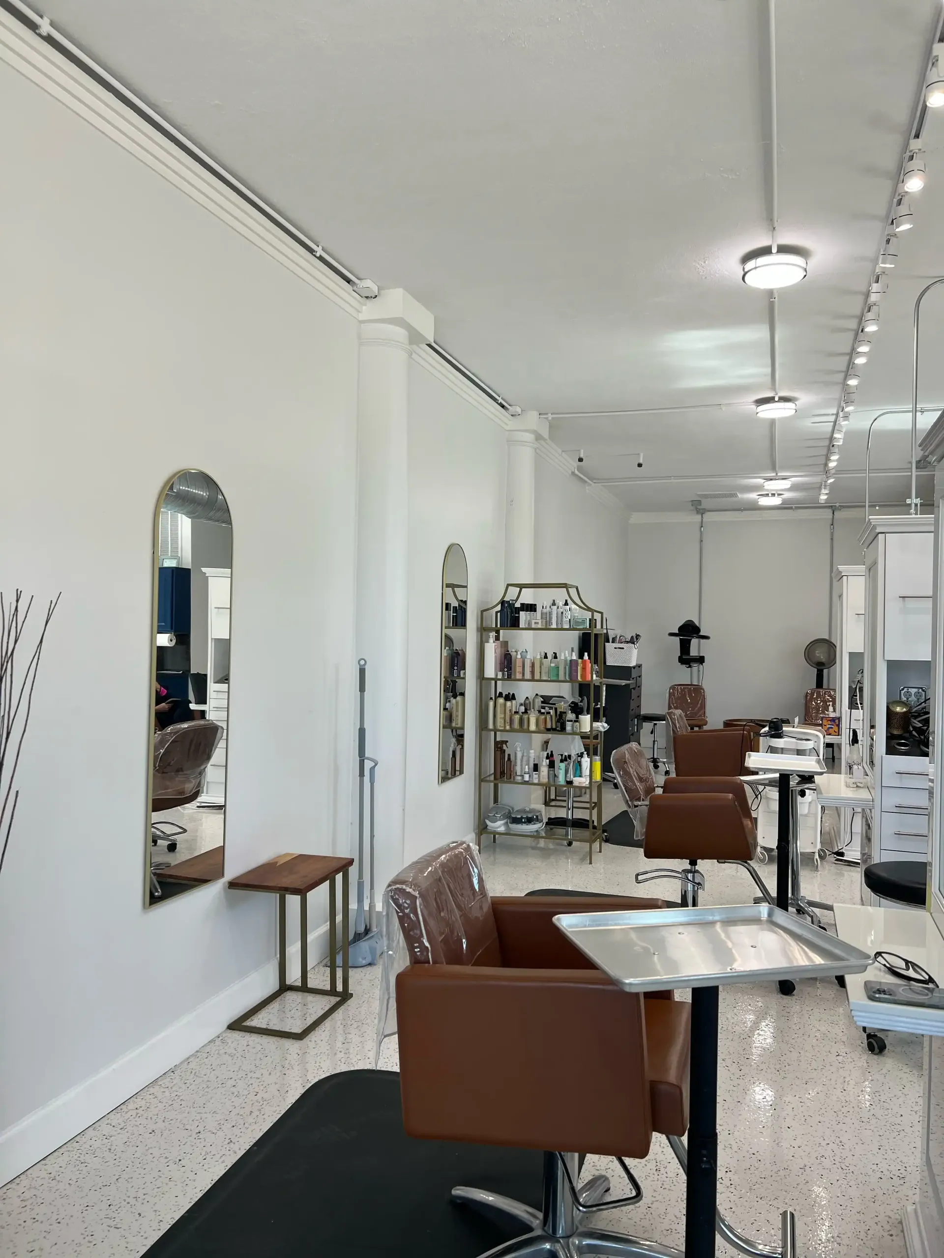 A hair salon with a lot of chairs and mirrors