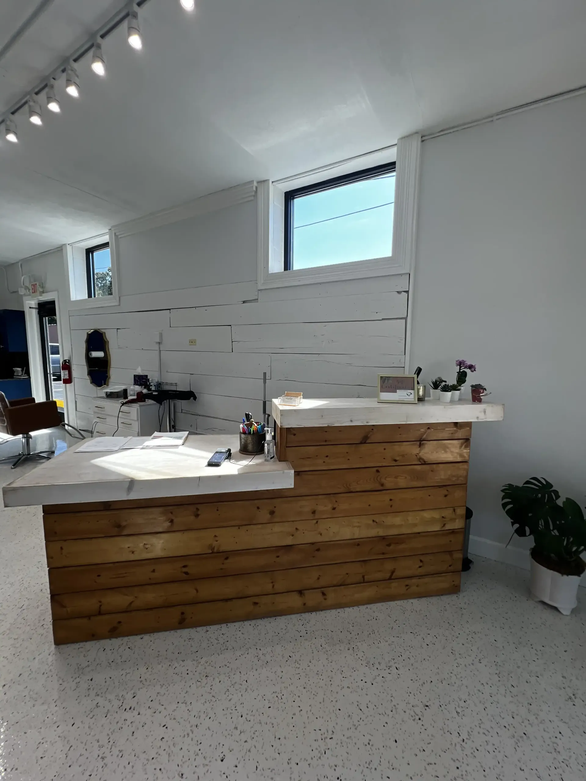 There is a wooden counter in the middle of the room.