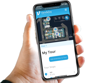 A hand is holding a phone that says my tour on the screen