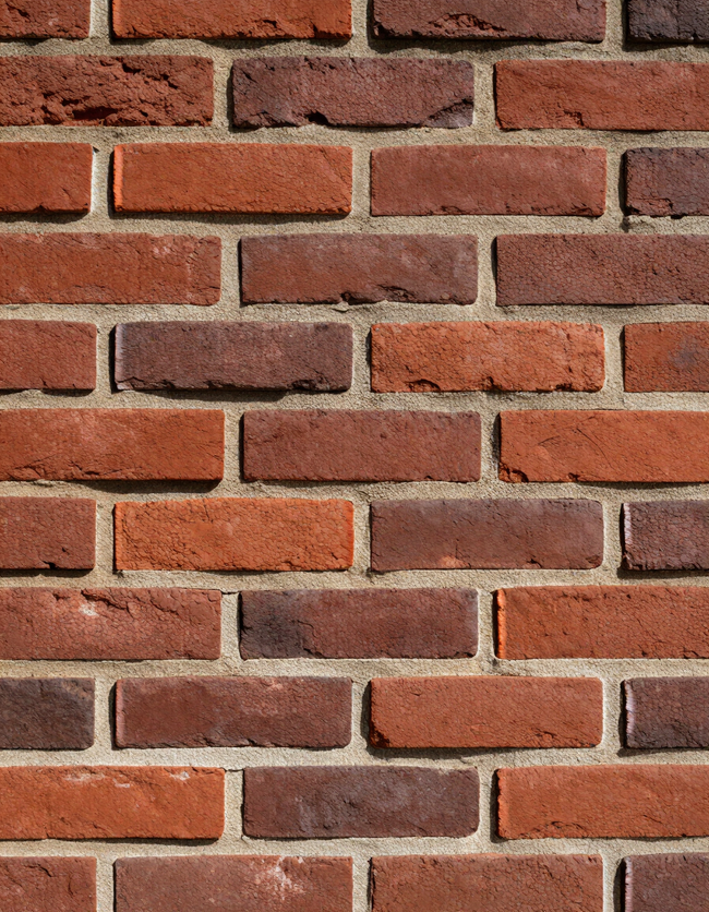 Red brick wall with staggered mortar lines and a weathered, rustic texture