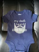 Blue baby onesie with text: 