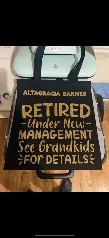 Black tote bag with gold lettering: