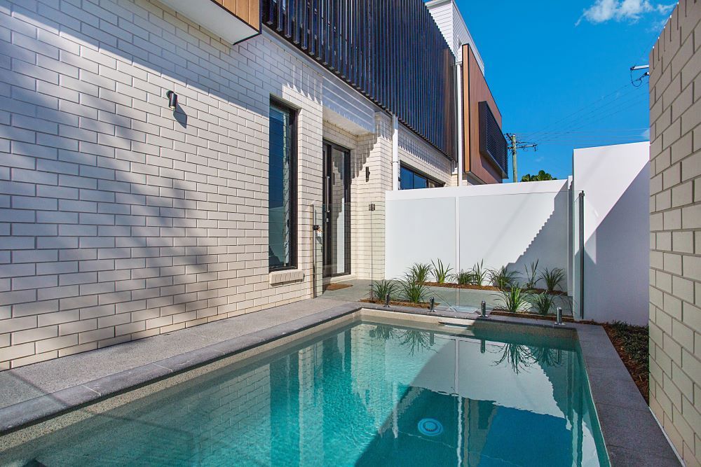 Two Cars Are Parked in Front of a Modern House — Beith Building & Developments Pty Ltd In Burleigh Heads, QLD