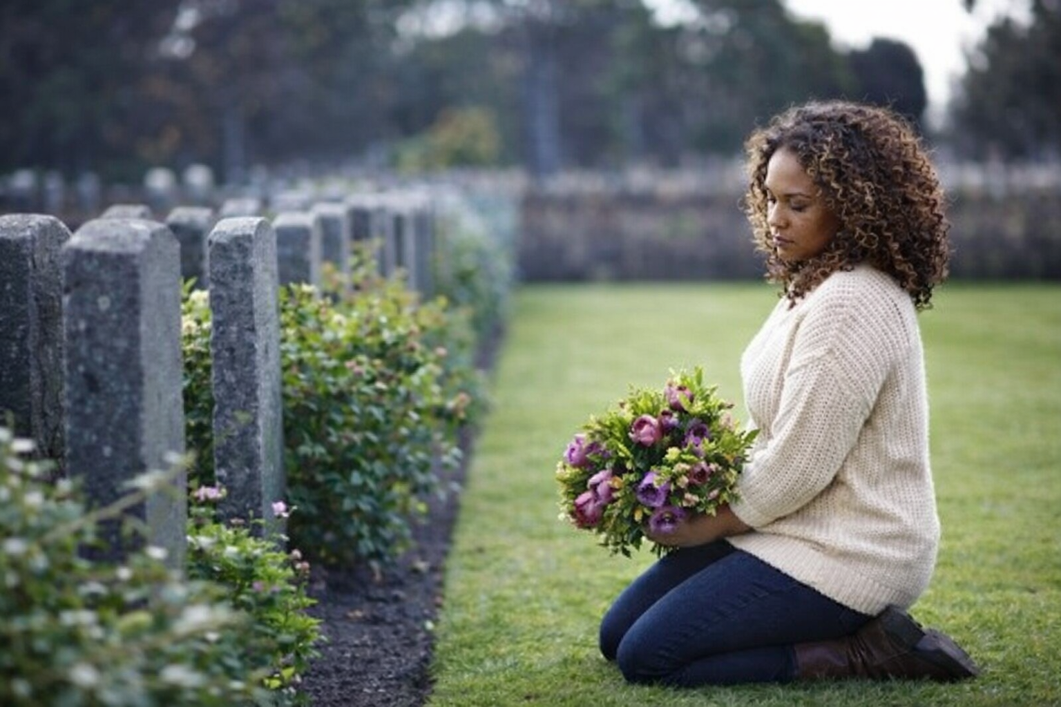 Person sitting on a bench grieving