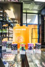 Display wall of vape devices and e-liquid bottles
