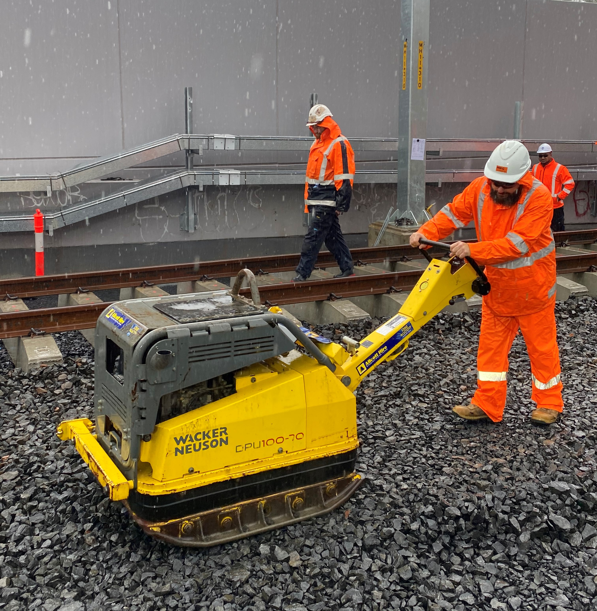 A man pulling a yellow machine