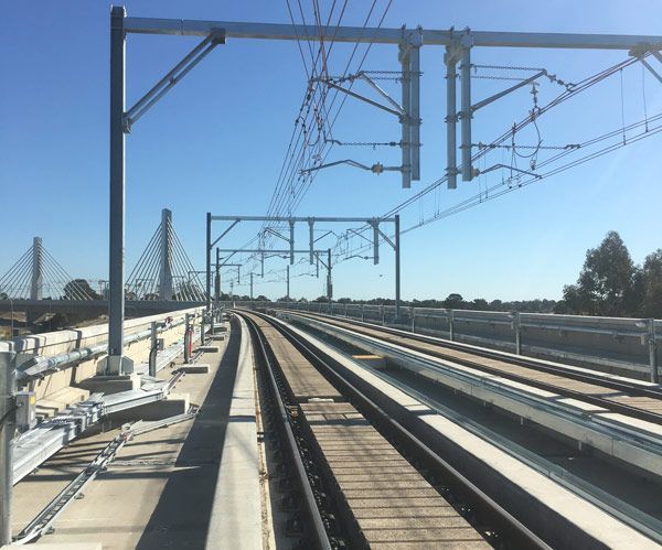A train track with a bridge in the background