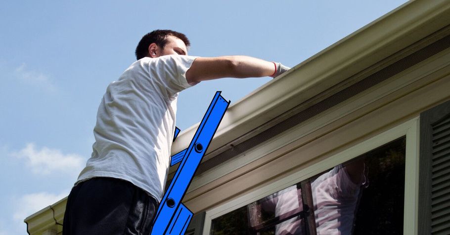 Person on a blue ladder working on a house roof gutter under a blue sky