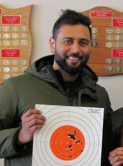 male holding target from shooting at the range