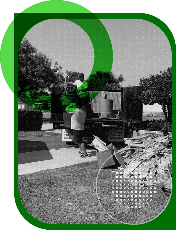 A black and white photo of a man loading a truck