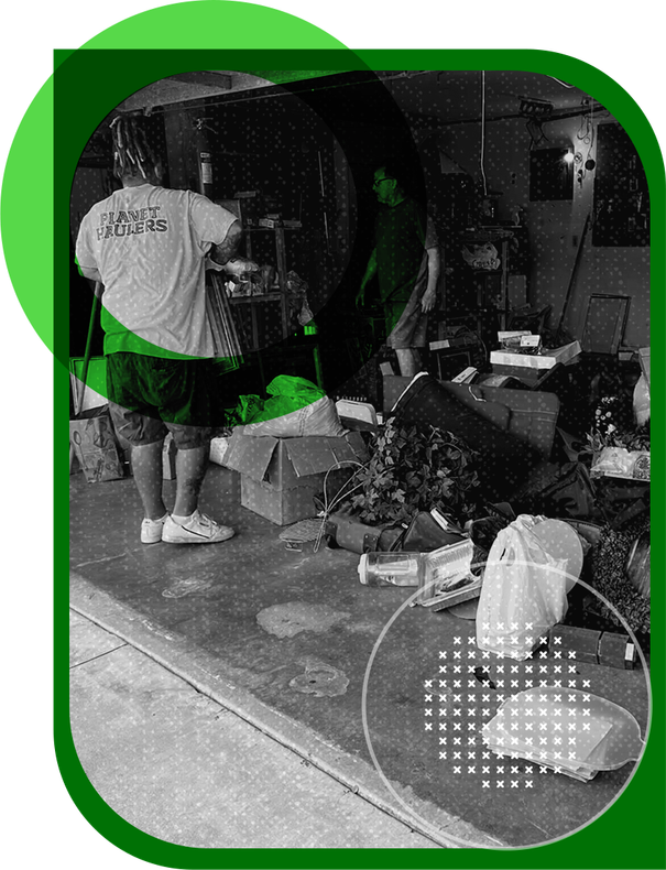 A man in a white shirt is standing in a messy room.