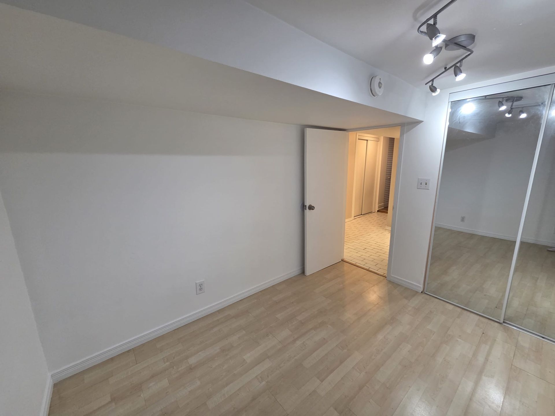 Second bedroom with hardwood floor and above‑grade window, 19 Orley Ave Lower by Laura Cooper Realtor 