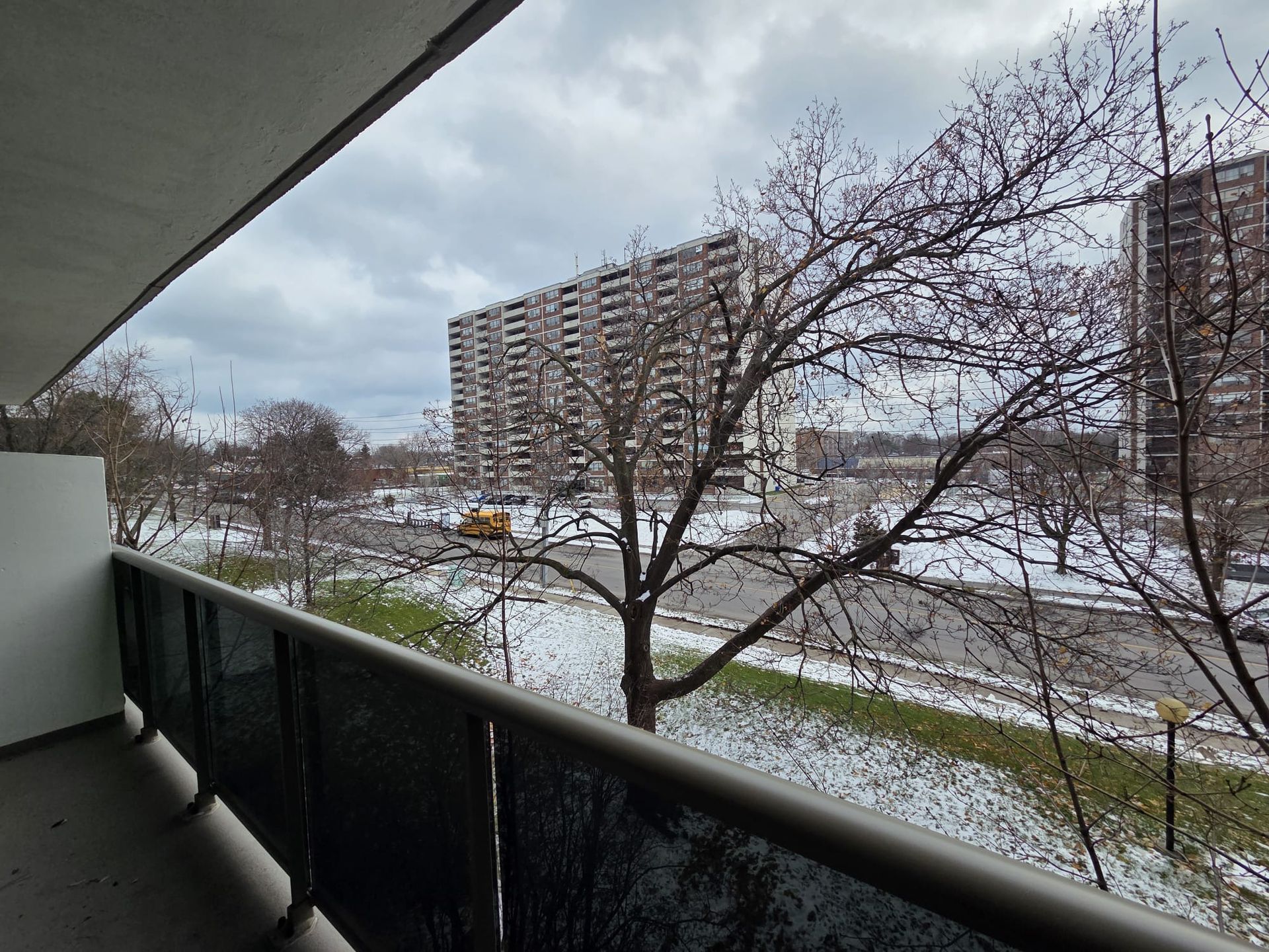South‑facing covered balcony with city and neighbourhood views, Laura Cooper Realtor
