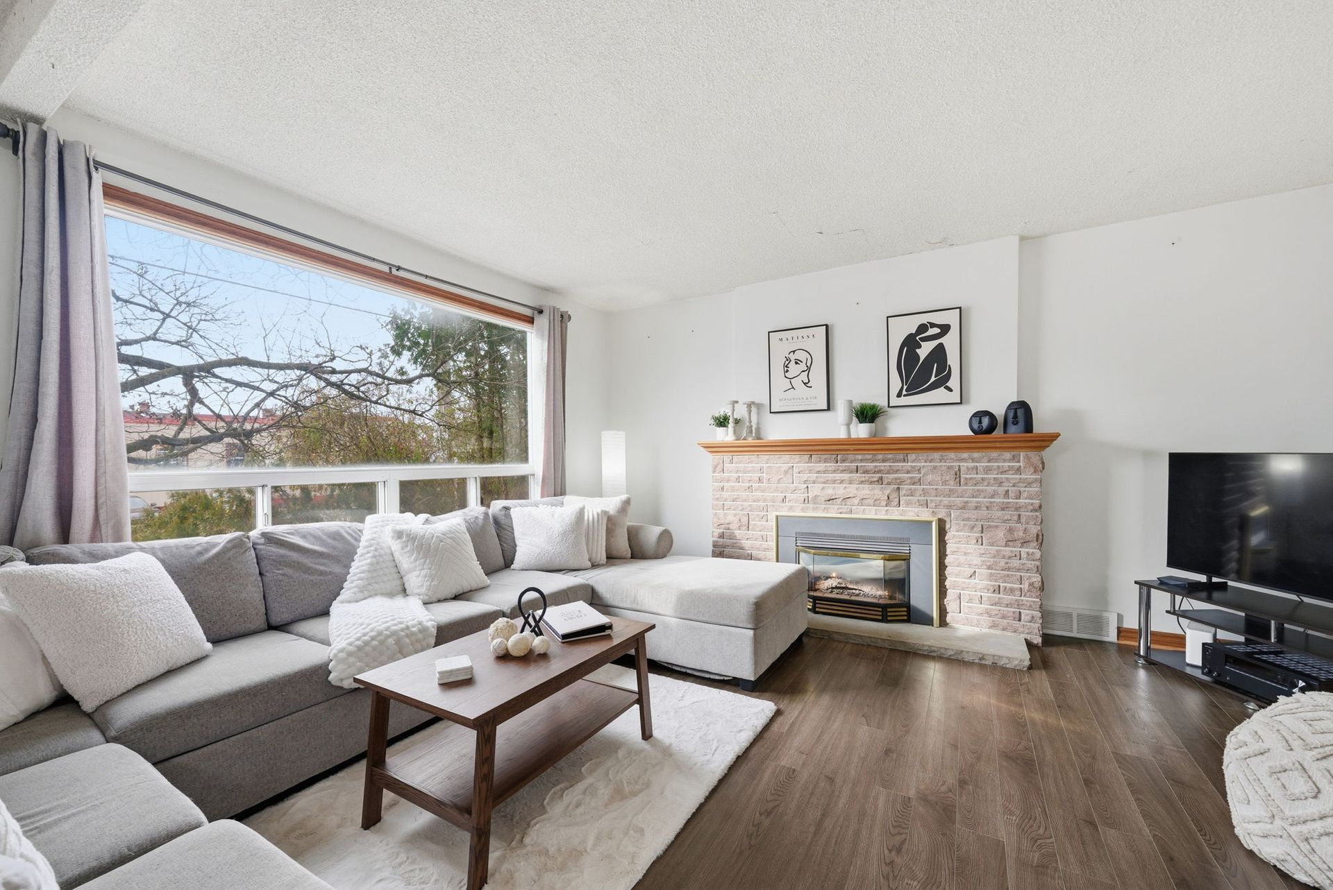 Living room detail showing cozy gas fireplace, listed by Laura Cooper Realtor