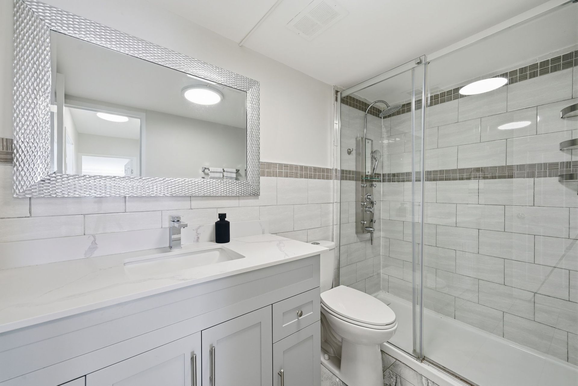 Updated main bathroom with modern fixtures, listed by Laura Cooper Realtor