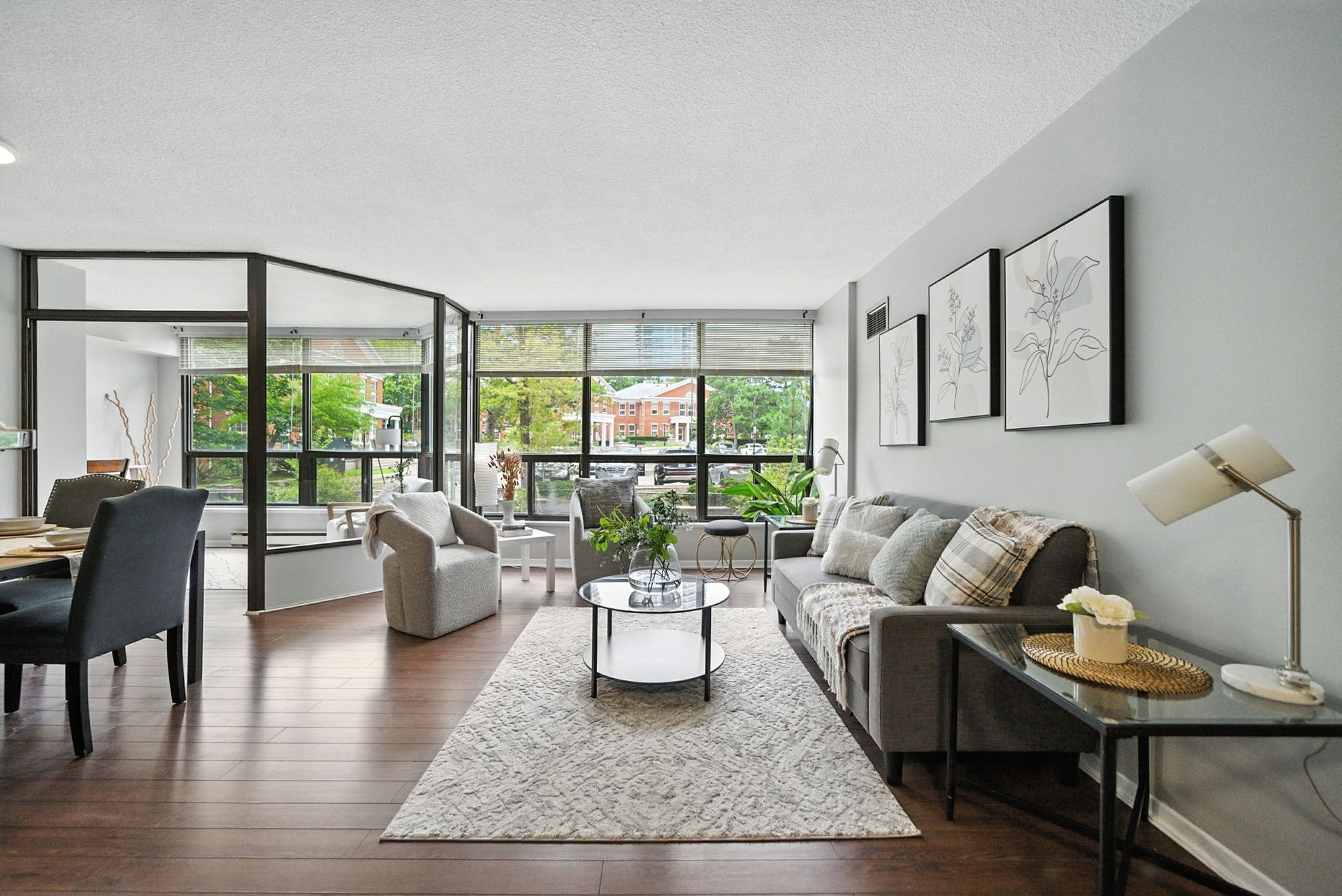 Living room with oversized corner windows, 201 – 200 Robert Speck Parkway by Laura Cooper Realtor