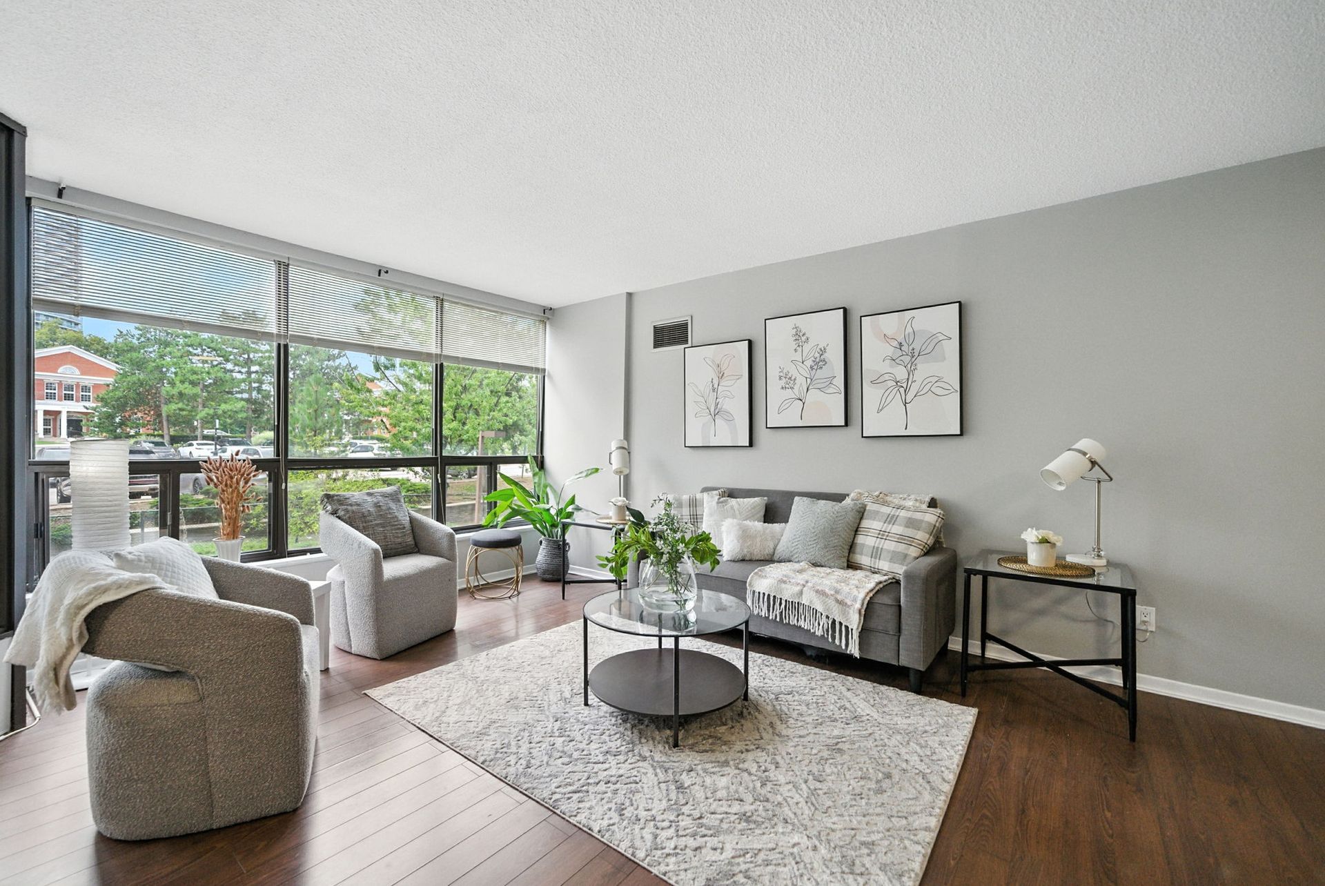 Living room with oversized corner windows, 201 – 200 Robert Speck Parkway by Laura Cooper Realtor