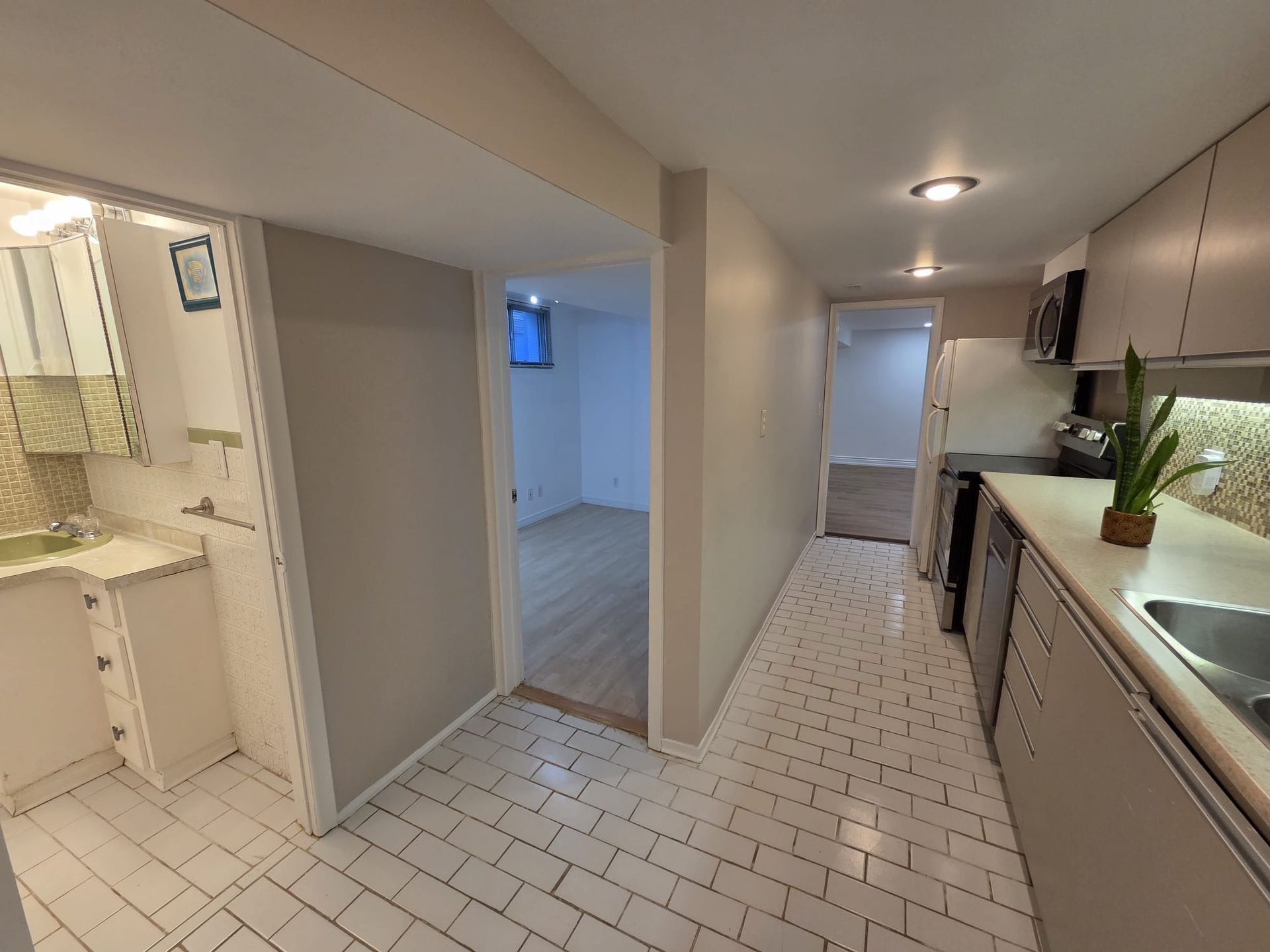 Galley kitchen with stainless steel appliances and built‑in dishwasher, Laura Cooper Realtor