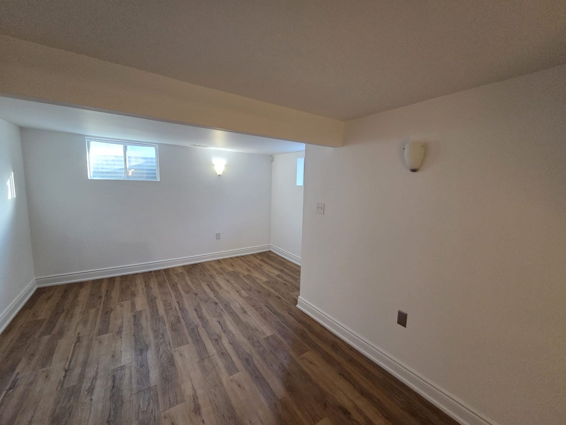 Open living and dining area with large above‑grade windows, Laura Cooper Realtor Toronto listing