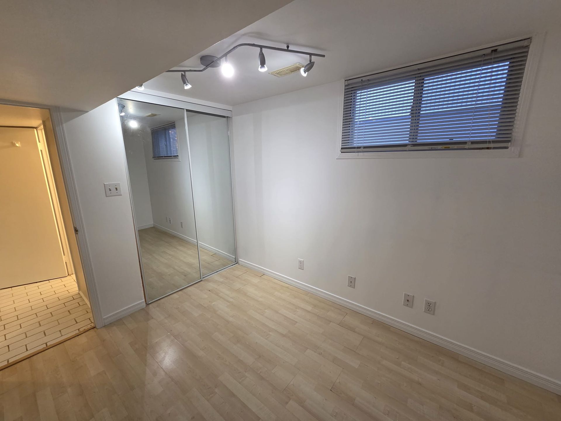 Primary bedroom with large closet and above‑grade window light, Laura Cooper Realtor Toronto 