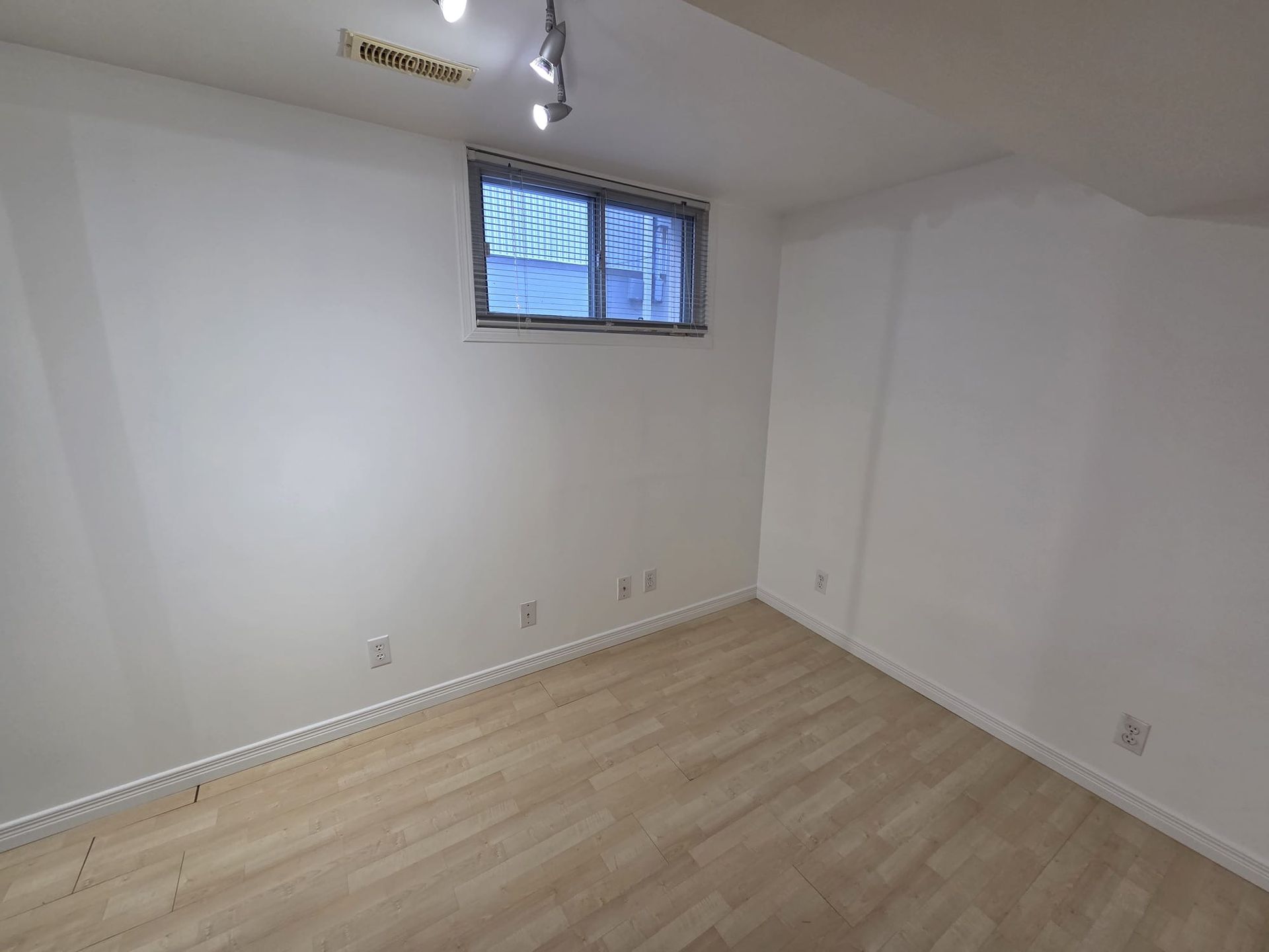 Primary bedroom with large closet and above‑grade window light, Laura Cooper Realtor Toronto 
