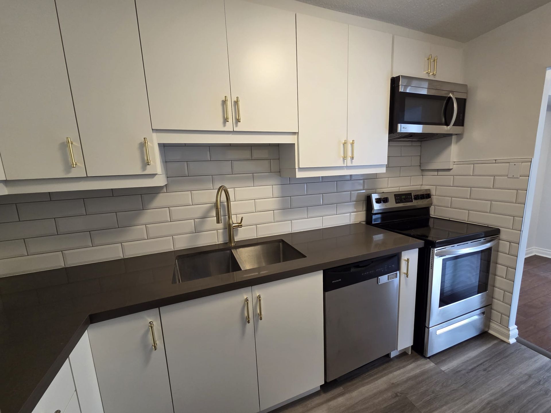Kitchen with stainless steel appliances and stone countertops, 314 condo by Laura Cooper Realtor