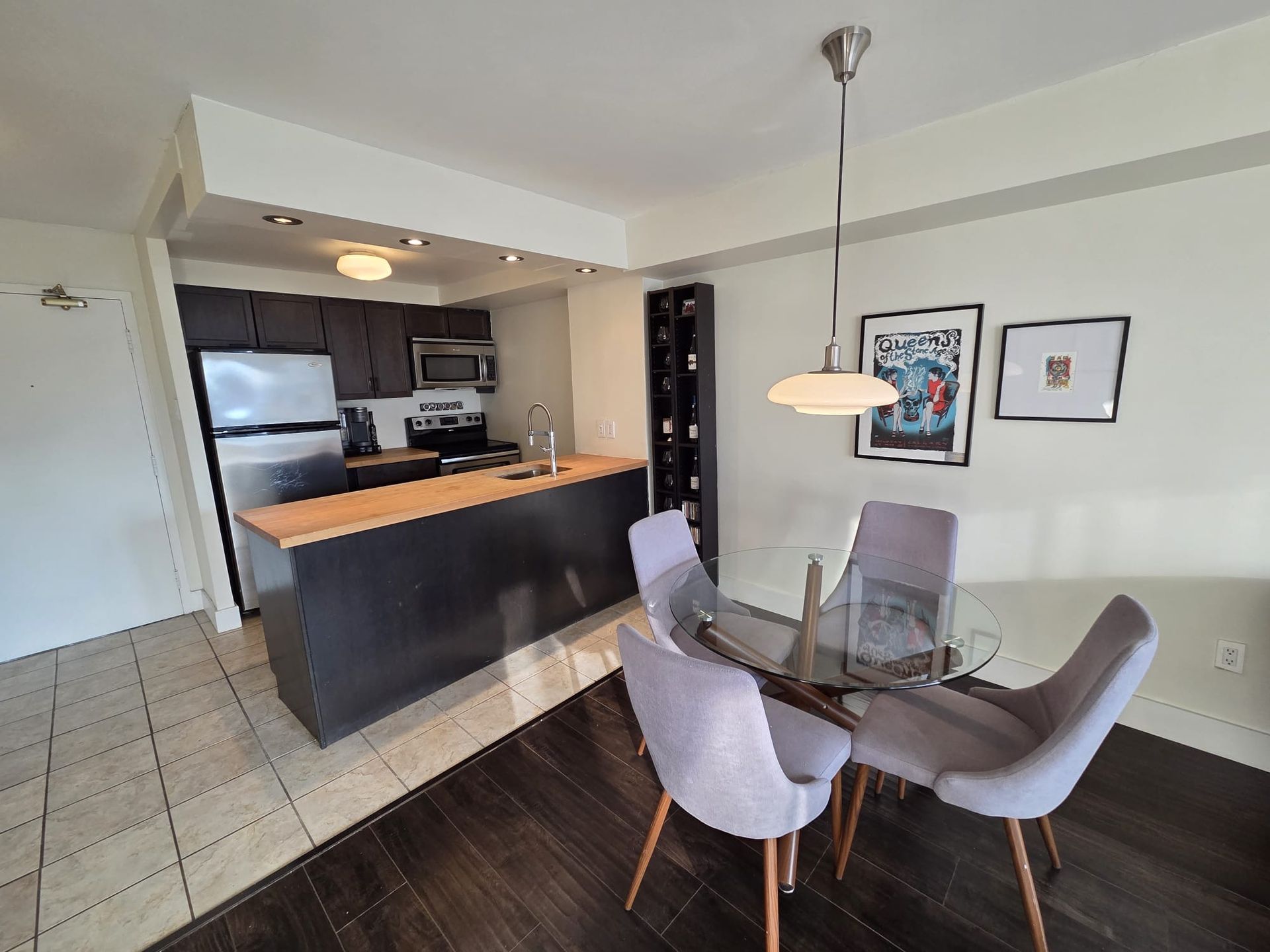 Dining area with table and chairs in furnished downtown condo by Laura Cooper Realtor