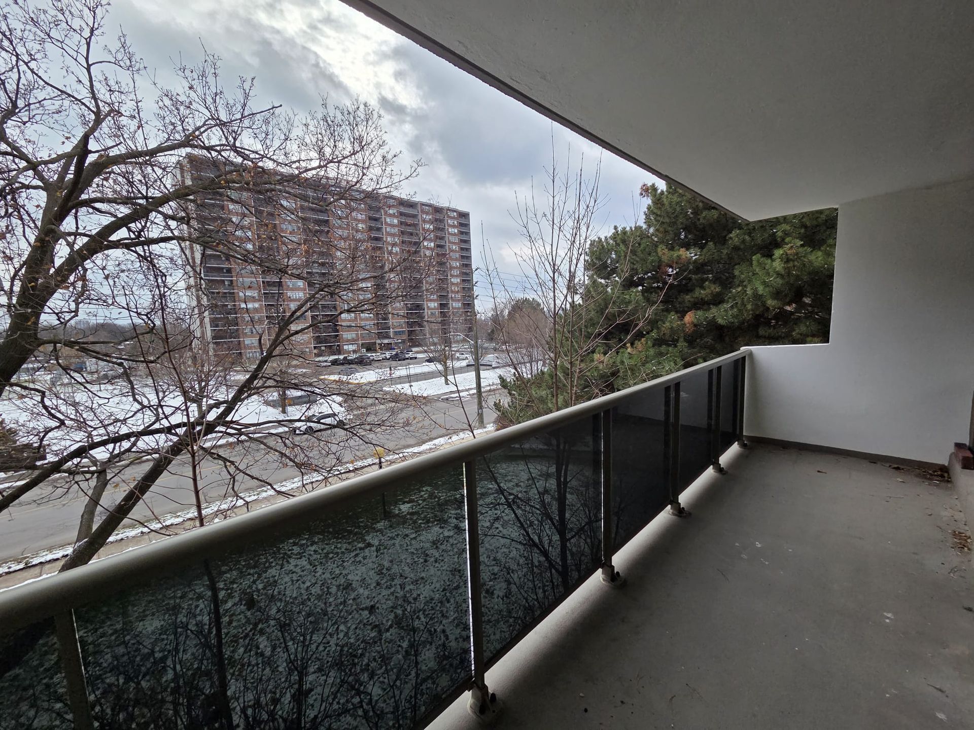 South‑facing covered balcony with city and neighbourhood views, Laura Cooper Realtor