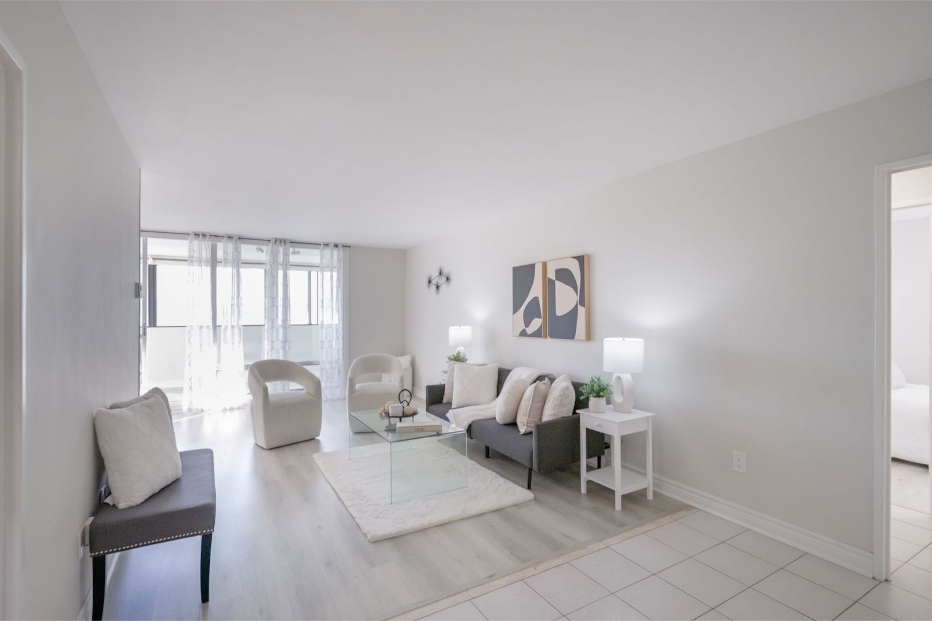 Massey Sq, Laura Cooper Realtor, For Sale, Sun-filled living room with large windows, Laura Cooper Toronto real estate listing