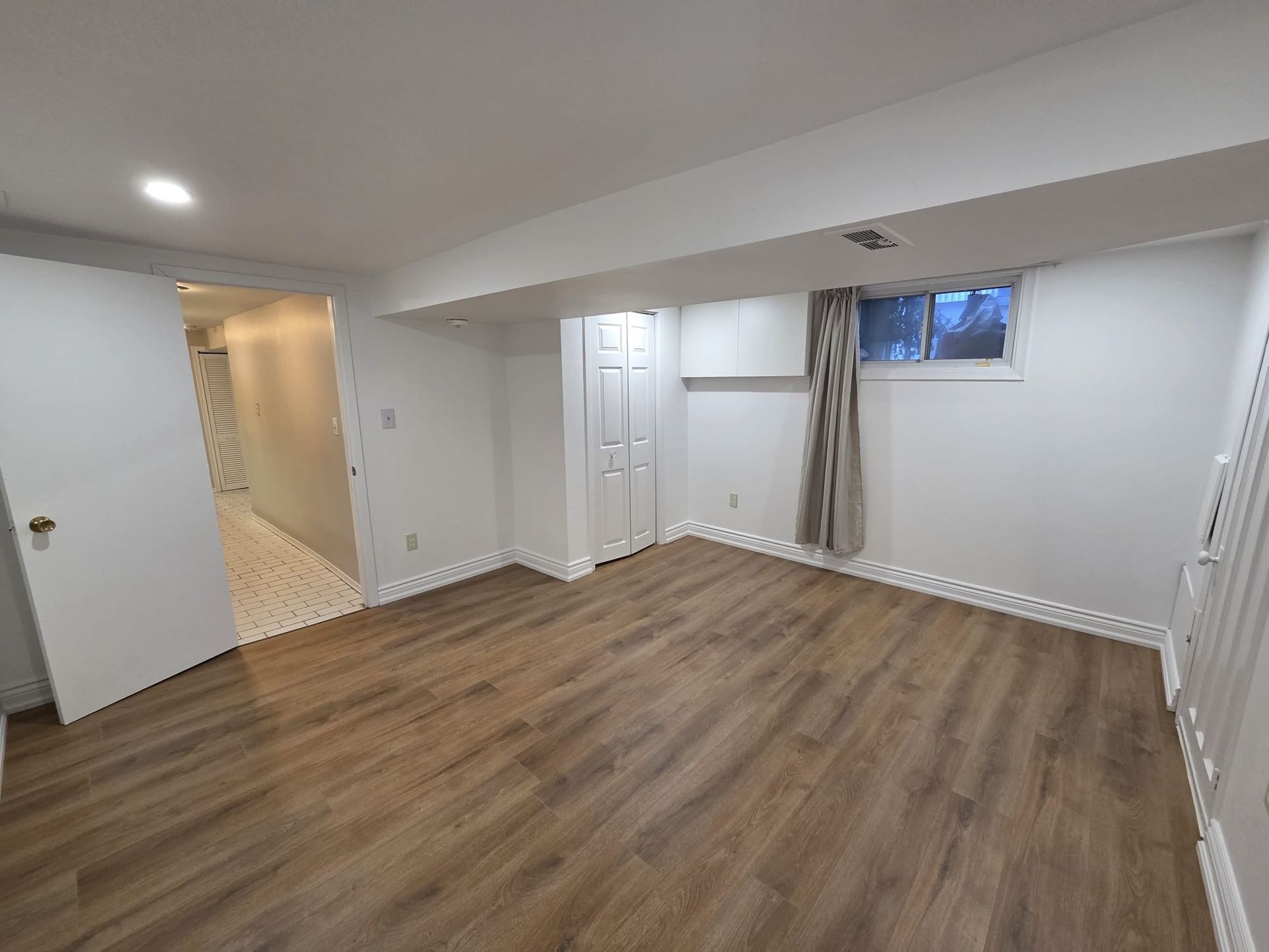 Second bedroom with hardwood floor and above‑grade window, 19 Orley Ave Lower by Laura Cooper Realtor 