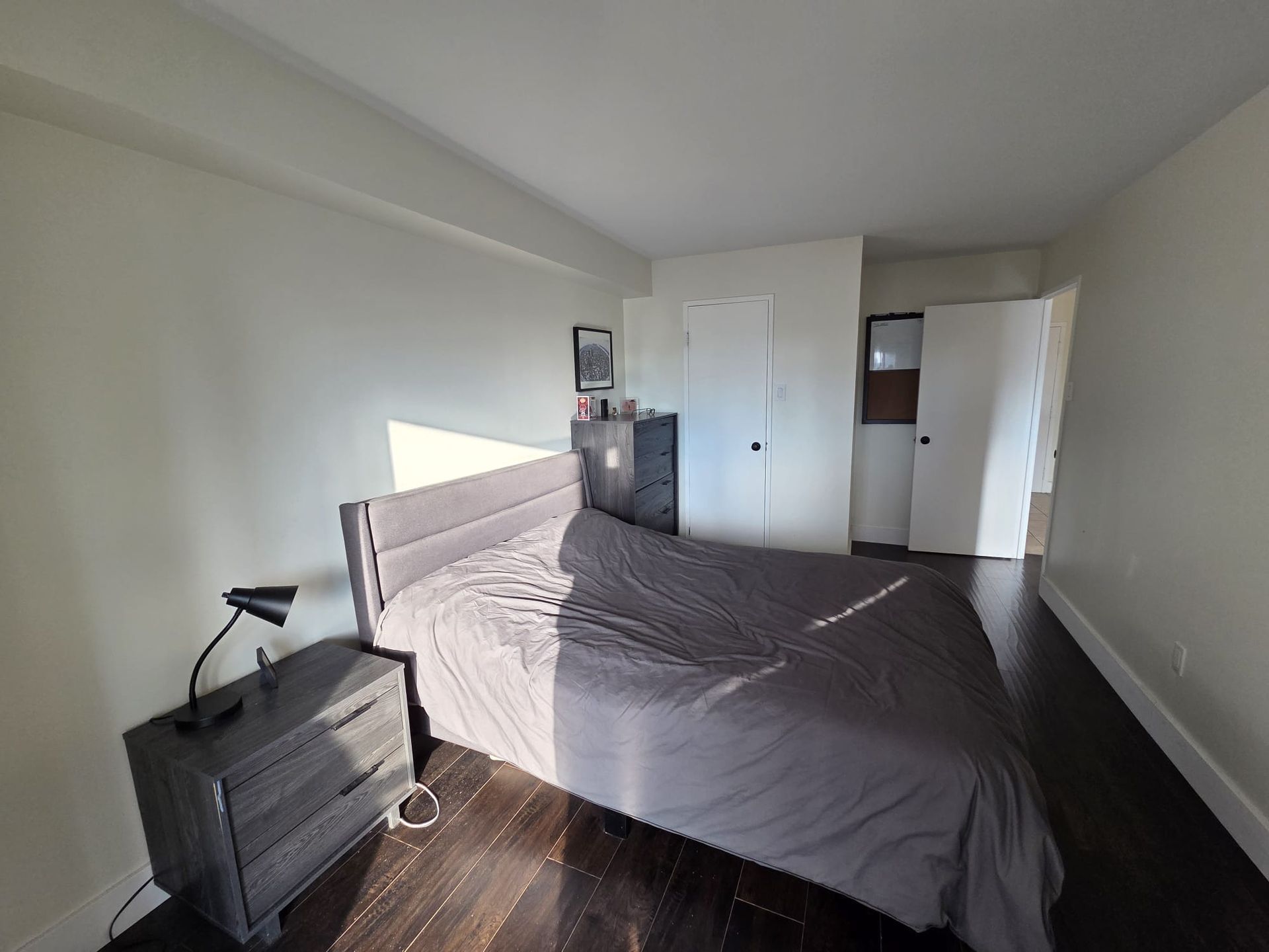 Primary bedroom with closet and large window light, 1111 condo by Laura Cooper Realtor