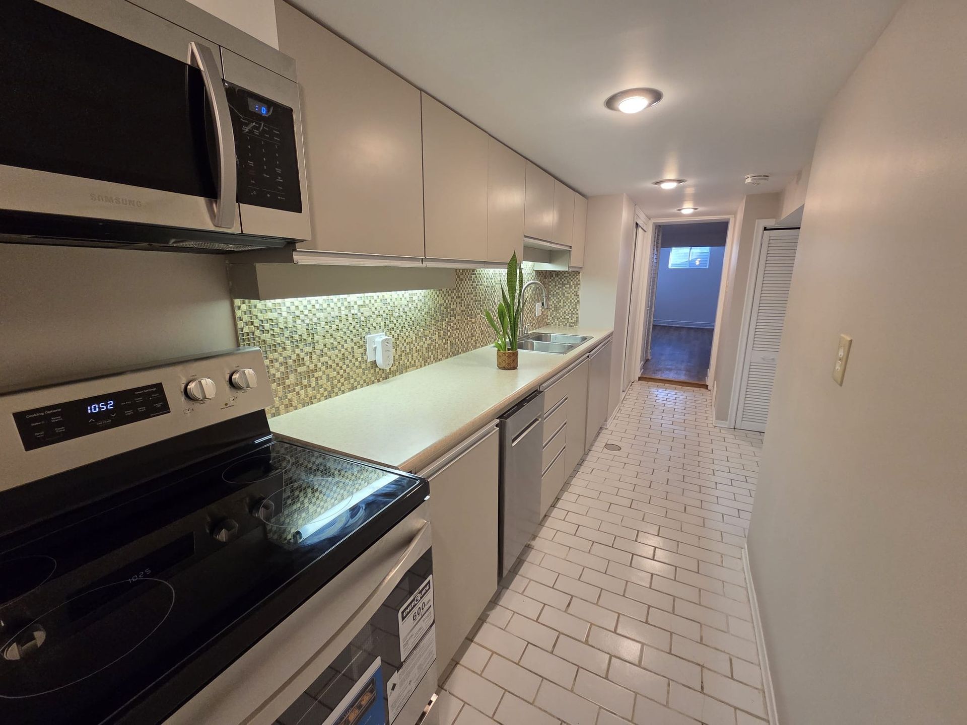 Kitchen countertop and cabinetry detail in lower level suite, listed by Laura Cooper Realtor