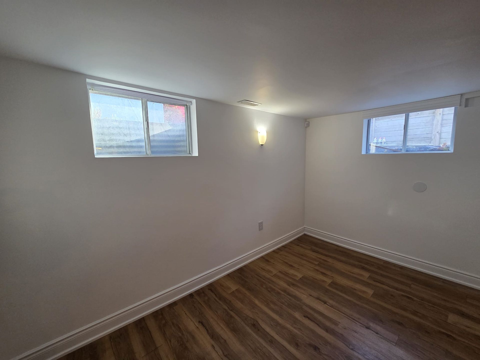 Open living and dining area with large above‑grade windows, Laura Cooper Realtor Toronto listing