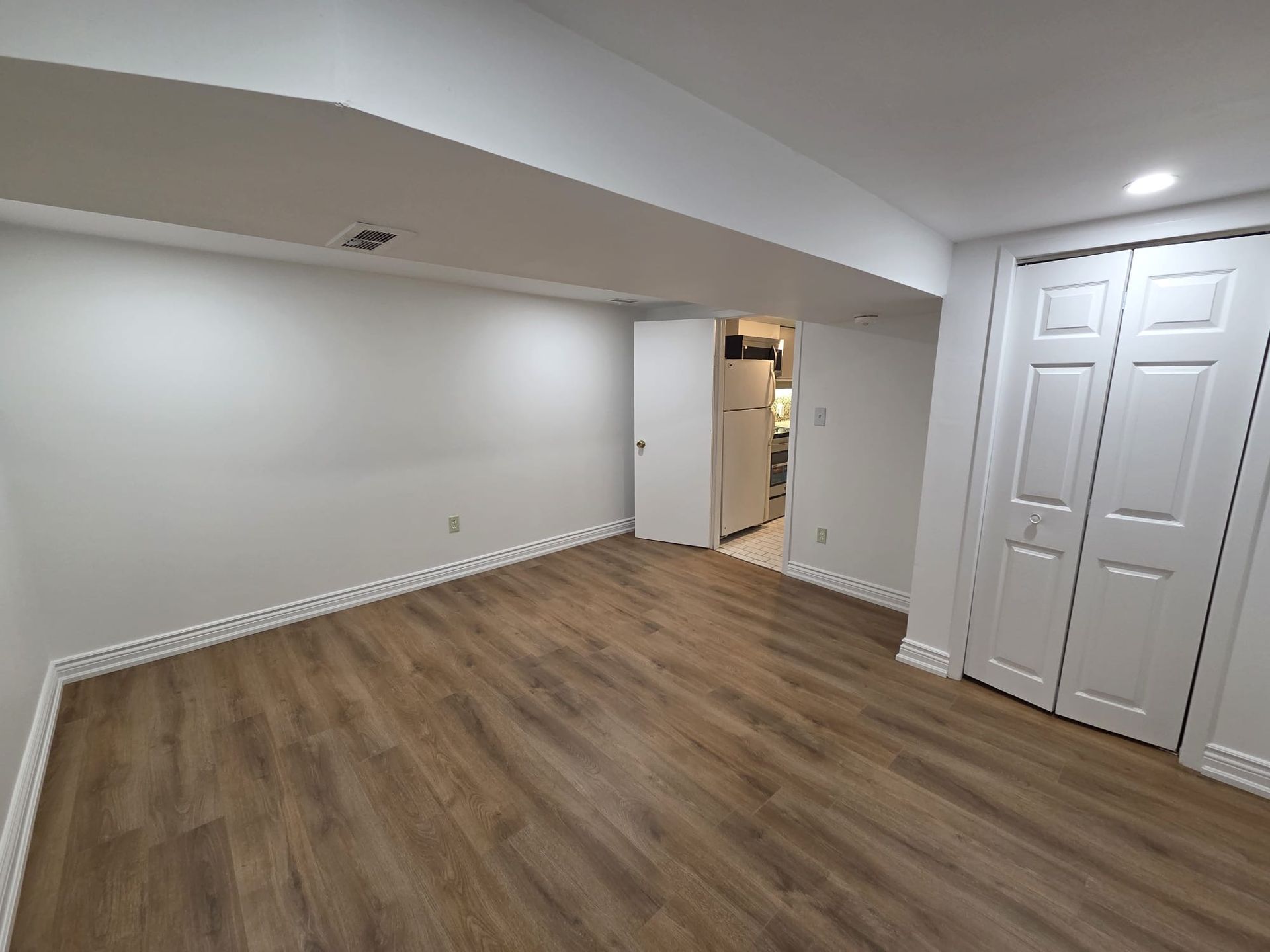 Second bedroom with hardwood floor and above‑grade window, 19 Orley Ave Lower by Laura Cooper Realtor 