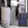 Basement furnace and water heater with metal ductwork and utility cabinets