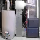 Basement furnace and water heater with metal ductwork and utility cabinets