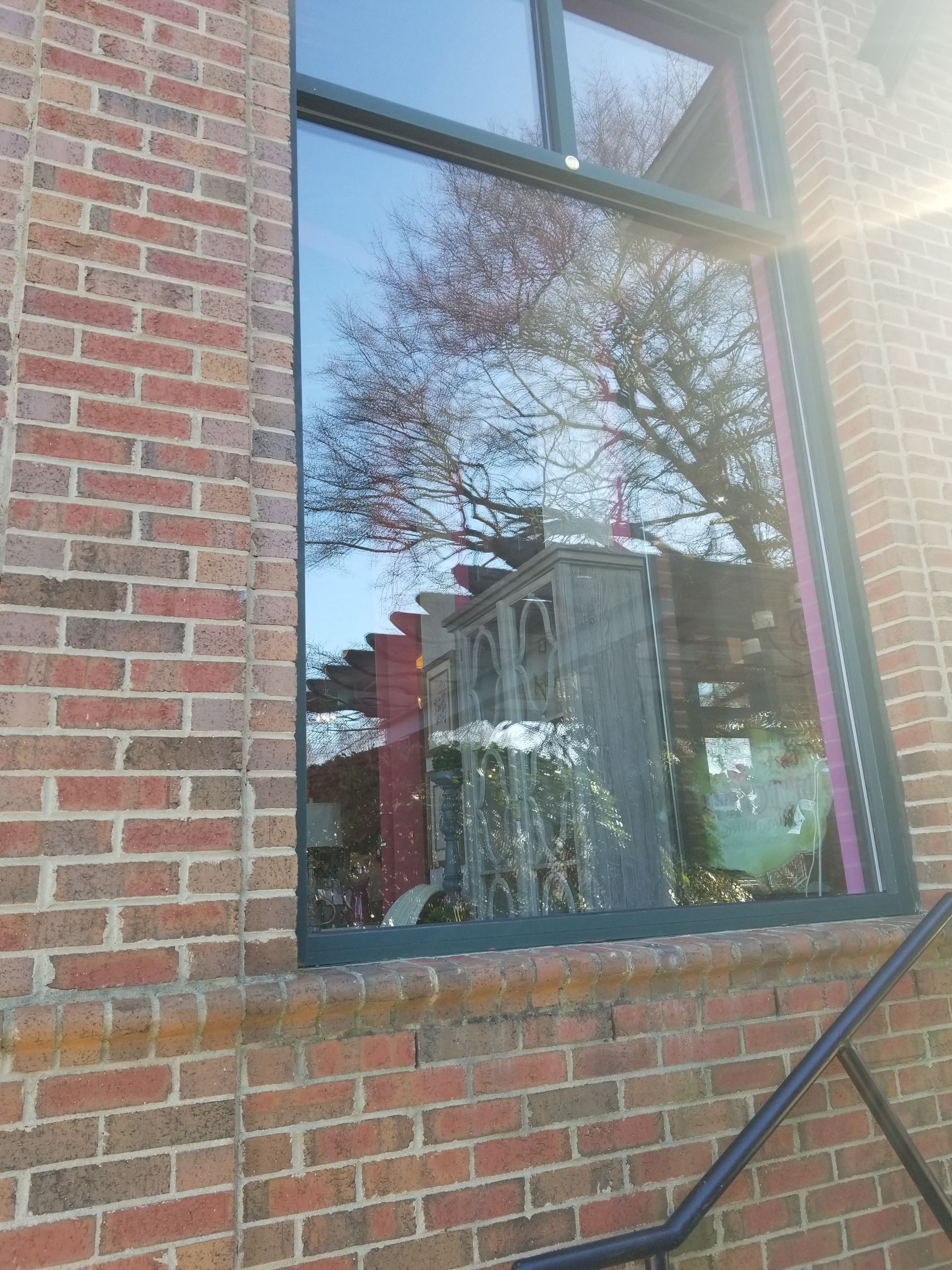 A brick building with a window and stairs leading up to it