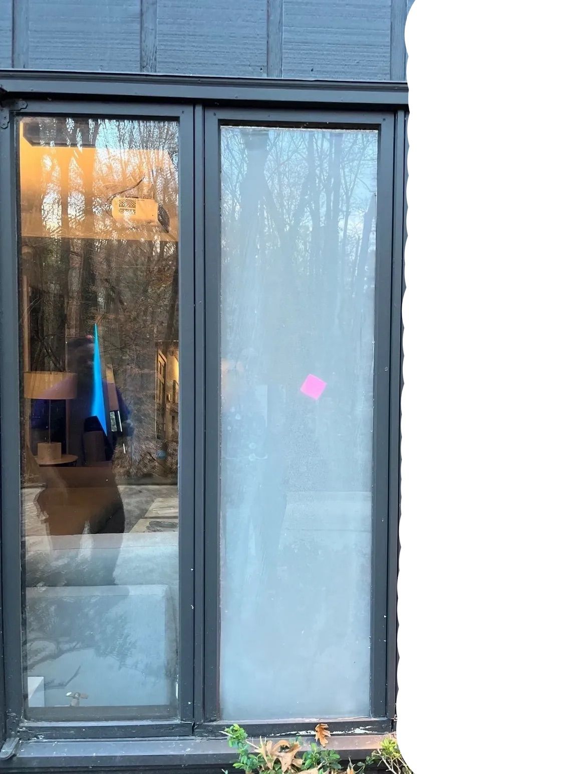 A window with a reflection of a person in it.