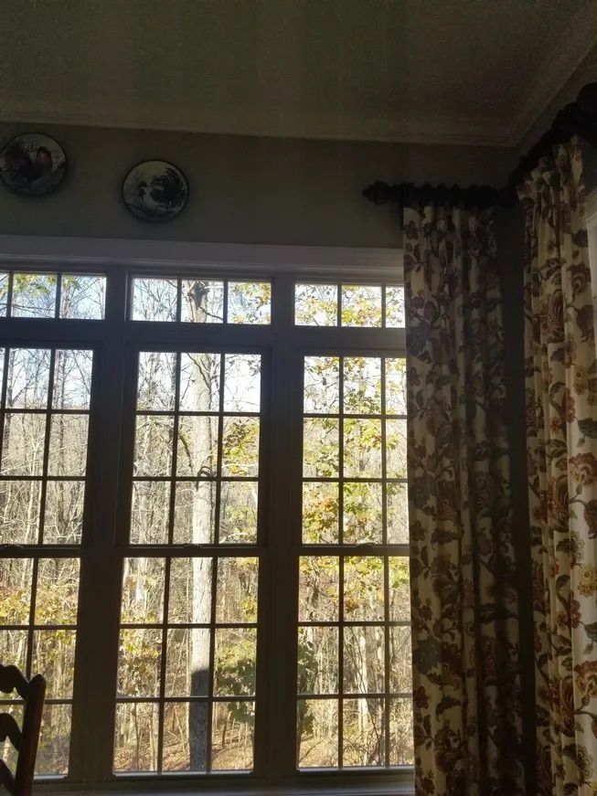 A room with a lot of windows and curtains